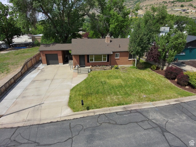 145 E 100 S, Farmington, UT 84025 - ranch-style home featuring concrete driveway, a garage, roof with shingles, a front lawn, and a chimney