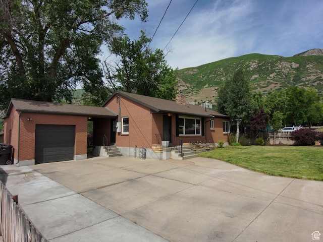 145 E 100 S, Farmington, UT 84025 - view of front of house with a garage, driveway, a mountain view, and brick siding