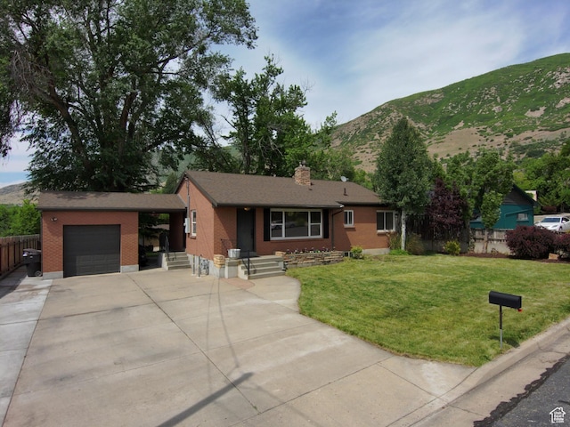 145 E 100 S, Farmington, UT 84025 - single story home featuring a mountain view, a garage, brick siding, concrete driveway, and a chimney