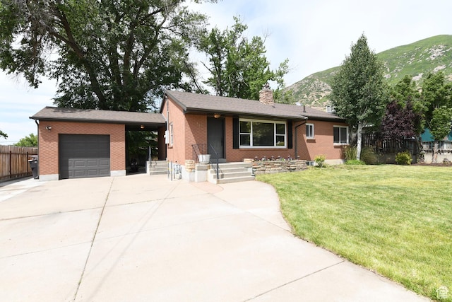 145 E 100 S, Farmington, UT 84025 - single story home with an attached garage, concrete driveway, brick siding, and a mountain view