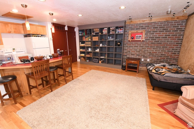 145 E 100 S, Farmington, UT 84025 - living room featuring light wood-type flooring, brick wall, and recessed lighting