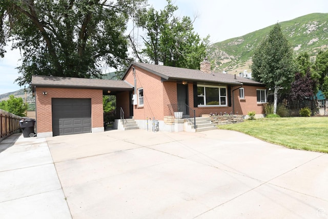 145 E 100 S, Farmington, UT 84025 - ranch-style home featuring an attached garage, concrete driveway, a mountain view, brick siding, and a chimney