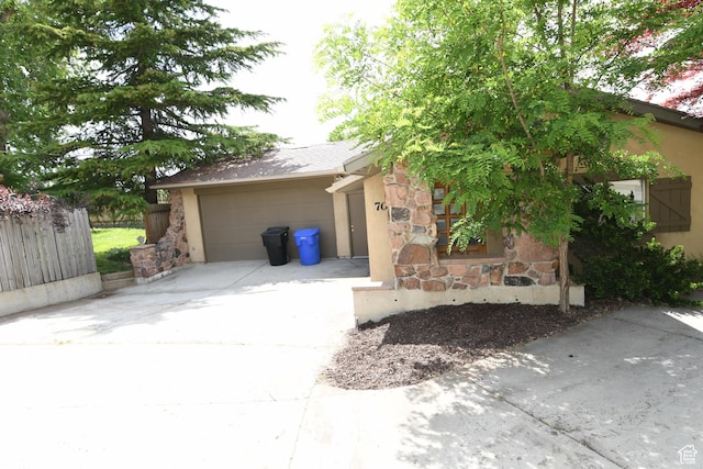 145 E 100 S, Farmington, UT 84025 - view of front of property featuring stone siding, driveway, a garage, and stucco siding