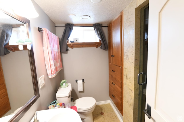 145 E 100 S, Farmington, UT 84025 - bathroom with toilet, a textured ceiling, baseboards, and tile patterned flooring