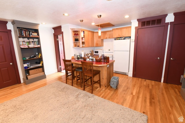 145 E 100 S, Farmington, UT 84025 - kitchen with white appliances, open shelves, a peninsula, light wood-style flooring, and a breakfast bar