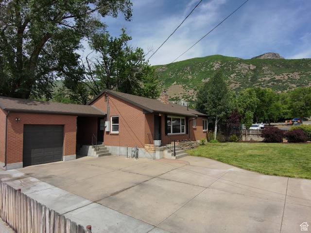 145 E 100 S, Farmington, UT 84025 - view of front facade featuring brick siding, an attached garage, driveway, and a mountain view