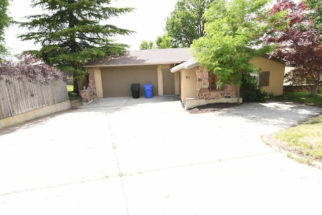 145 E 100 S, Farmington, UT 84025 - view of front of home with stone siding, concrete driveway, stucco siding, and an attached garage