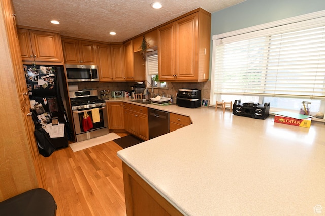 145 E 100 S, Farmington, UT 84025 - kitchen with stainless steel appliances, recessed lighting, a textured ceiling, light countertops, and a sink