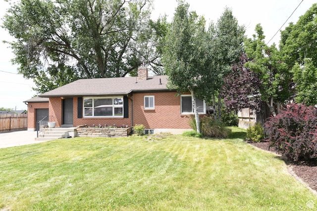 145 E 100 S, Farmington, UT 84025 - ranch-style home featuring a chimney, a garage, brick siding, and concrete driveway