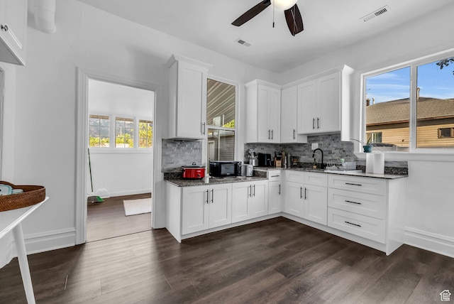 158 N 900 W, Provo, UT 84601 - kitchen featuring ceiling fan, decorative backsplash, dark wood-style flooring, white cabinets, and dark stone countertops