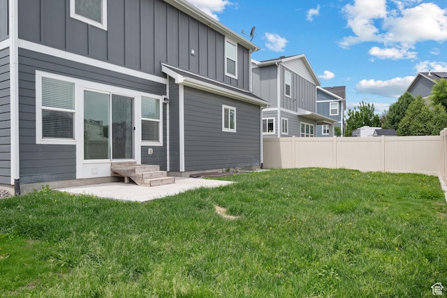 4959 Sagebrush Ln E, Eagle Mountain, UT 84005 - rear view of house with board and batten siding and a patio area