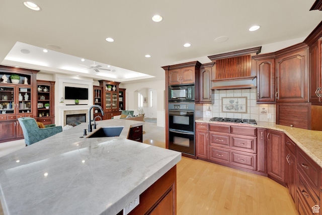7195 S Villandrie Ln E, Cottonwood Heights, UT 84121 - kitchen featuring a sink, black appliances, ceiling fan, recessed lighting, and a glass covered fireplace