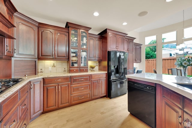 7195 S Villandrie Ln E, Cottonwood Heights, UT 84121 - kitchen featuring black appliances, light wood finished floors, recessed lighting, backsplash, and hanging light fixtures