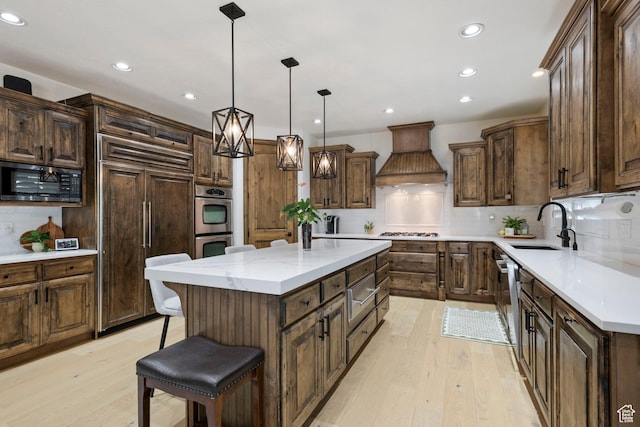 2908 W Bison Ridge Rd, South Jordan, UT 84095 - kitchen with custom exhaust hood, stainless steel appliances, a warming drawer, light wood-type flooring, and recessed lighting