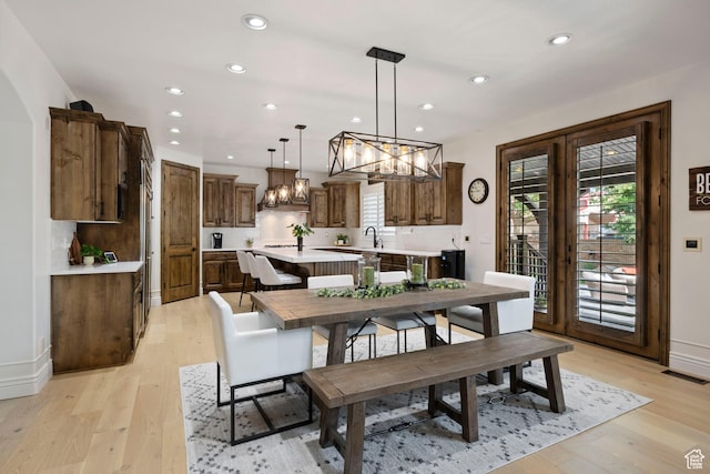 2908 W Bison Ridge Rd, South Jordan, UT 84095 - dining space featuring a chandelier, recessed lighting, light wood-style floors, and baseboards