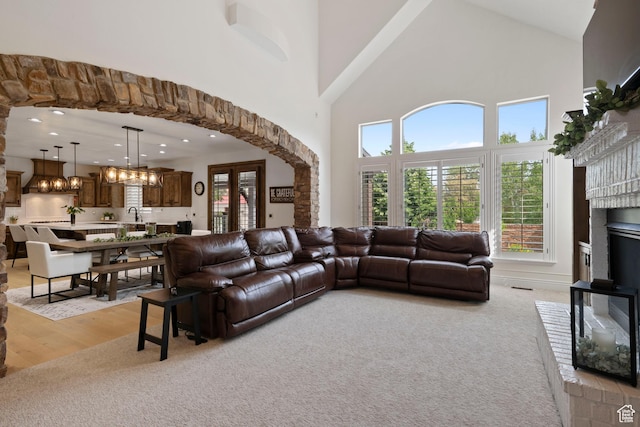 2908 W Bison Ridge Rd, South Jordan, UT 84095 - living area featuring high vaulted ceiling, light colored carpet, recessed lighting, a chandelier, and a fireplace with raised hearth