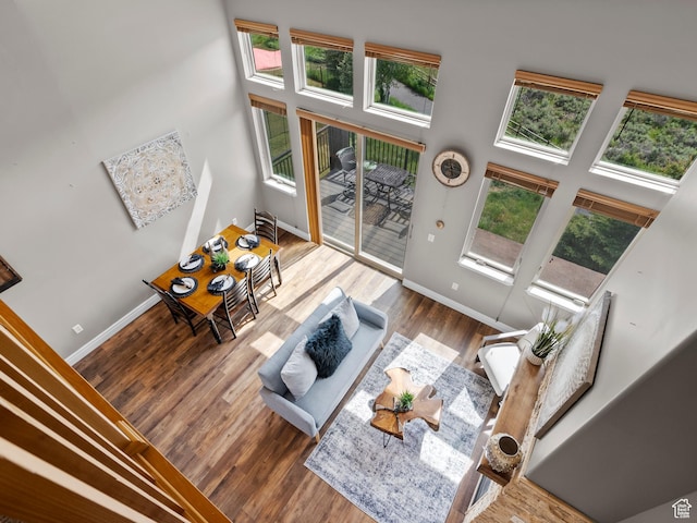 6749 N 2200 W Unit B-303, Park City, UT 84098 - living area with baseboards, wood finished floors, and a high ceiling