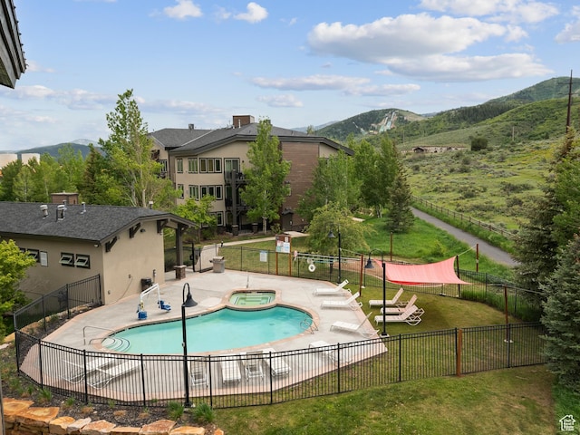 6749 N 2200 W Unit B-303, Park City, UT 84098 - community pool with a hot tub, a mountain view, and a patio