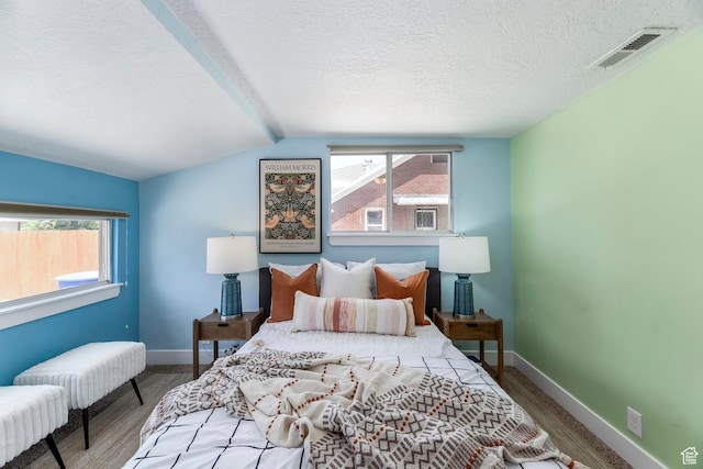 1860 S 800 E, Salt Lake City, UT 84105 - bedroom featuring multiple windows, wood finished floors, a textured ceiling, baseboards, and vaulted ceiling