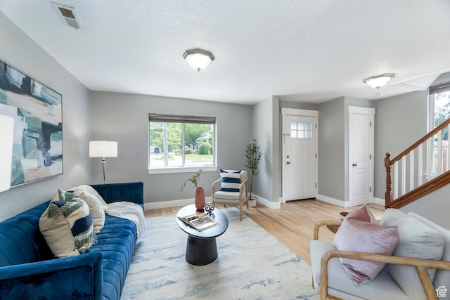 1860 S 800 E, Salt Lake City, UT 84105 - living area with plenty of natural light, wood finished floors, a textured ceiling, baseboards, and stairs