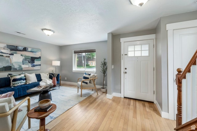 1860 S 800 E, Salt Lake City, UT 84105 - foyer entrance with baseboards, healthy amount of natural light, light wood-style floors, and a textured ceiling