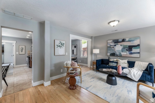 1860 S 800 E, Salt Lake City, UT 84105 - living room with light wood-type flooring, a textured ceiling, and baseboards