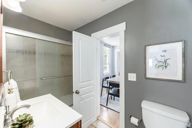 1860 S 800 E, Salt Lake City, UT 84105 - bathroom with vanity, toilet, wood finished floors, a textured ceiling, and a shower