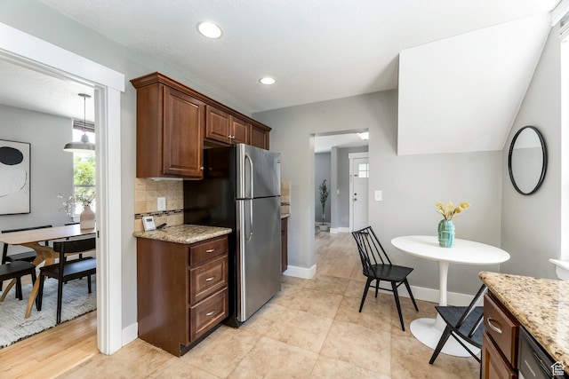 1860 S 800 E, Salt Lake City, UT 84105 - kitchen with freestanding refrigerator, backsplash, light stone countertops, baseboards, and recessed lighting