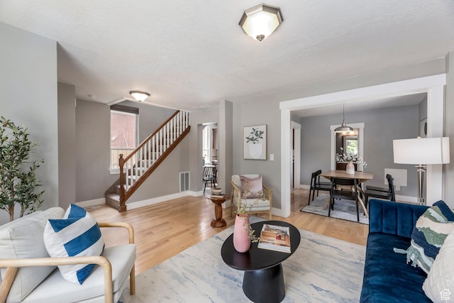 1860 S 800 E, Salt Lake City, UT 84105 - living area featuring wood finished floors, stairs, healthy amount of natural light, baseboards, and a textured ceiling