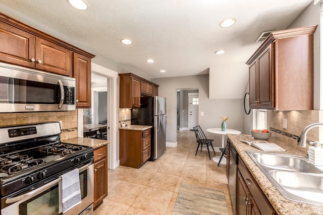 1860 S 800 E, Salt Lake City, UT 84105 - kitchen featuring appliances with stainless steel finishes, a sink, tasteful backsplash, recessed lighting, and light stone countertops
