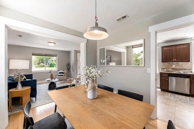 1860 S 800 E, Salt Lake City, UT 84105 - dining room featuring light wood-type flooring, baseboards, and a textured ceiling