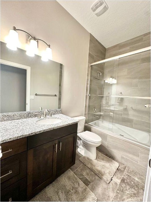 108 Trapper Cir Unit A, Springdale, UT 84767 - bathroom with toilet, tiled shower / bath, and vanity