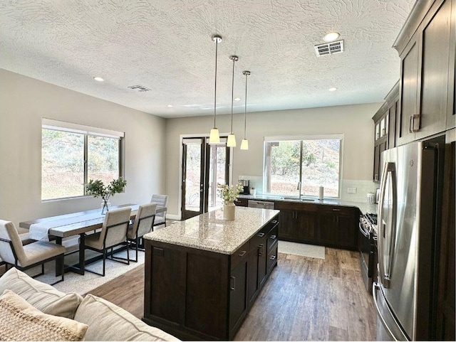 108 Trapper Cir Unit A, Springdale, UT 84767 - kitchen featuring stainless steel appliances, light wood-style floors, a center island, light stone countertops, and recessed lighting