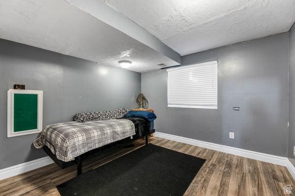 755 E 890 N, Tooele, UT 84074 - bedroom with baseboards, wood finished floors, and a textured ceiling