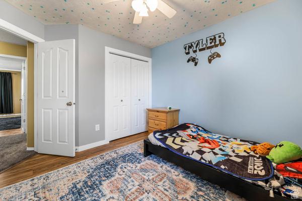 755 E 890 N, Tooele, UT 84074 - bedroom with wood finished floors, a closet, a ceiling fan, and baseboards