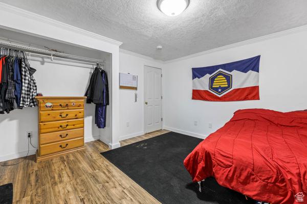 755 E 890 N, Tooele, UT 84074 - bedroom with a textured ceiling, wood finished floors, ornamental molding, and baseboards
