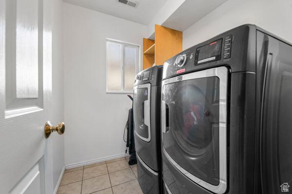 755 E 890 N, Tooele, UT 84074 - laundry room featuring separate washer and dryer, light tile patterned flooring, and baseboards