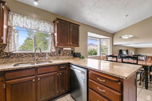 755 E 890 N, Tooele, UT 84074 - kitchen featuring stainless steel dishwasher, a sink, light tile patterned floors, lofted ceiling, and a peninsula