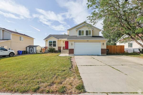 755 E 890 N, Tooele, UT 84074 - view of front of property featuring brick siding, driveway, and a garage