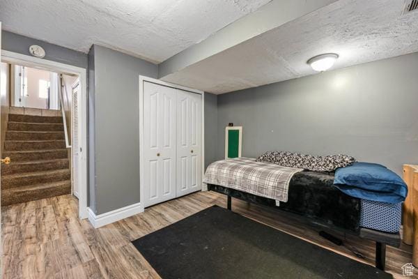 755 E 890 N, Tooele, UT 84074 - bedroom featuring wood finished floors, a textured ceiling, baseboards, and a closet