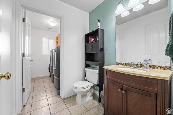 755 E 890 N, Tooele, UT 84074 - full bathroom featuring washer and clothes dryer, vanity, toilet, and tile patterned floors