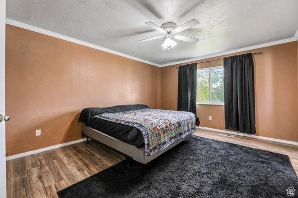 755 E 890 N, Tooele, UT 84074 - bedroom with wood finished floors, baseboards, crown molding, ceiling fan, and a textured ceiling