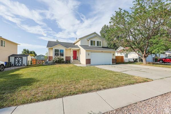 755 E 890 N, Tooele, UT 84074 - view of front of house featuring driveway, an attached garage, and brick siding