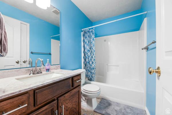 755 E 890 N, Tooele, UT 84074 - full bathroom featuring vanity, toilet, and shower / bath combination with curtain
