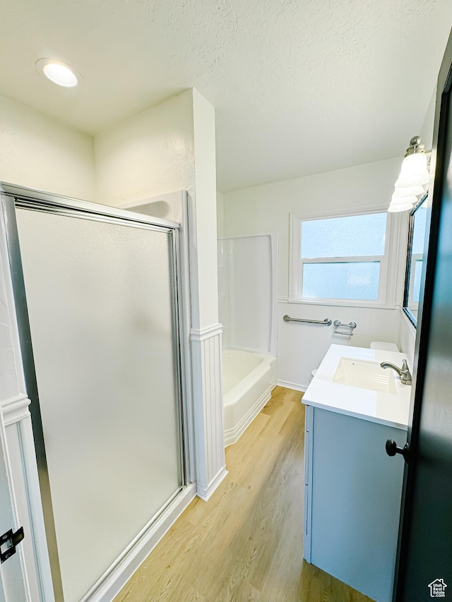 1797 N 5900 W, Warren, UT 84404 - bathroom featuring an enclosed shower, vanity, wood finished floors, a tub, and a textured ceiling