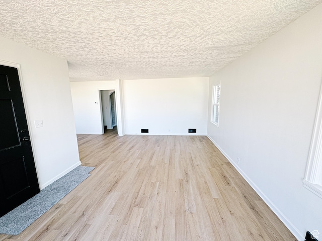 1797 N 5900 W, Warren, UT 84404 - empty room with light wood-style floors, baseboards, and a textured ceiling
