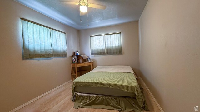 140 W 200 N, Price, UT 84501 - bedroom featuring light wood-style floors, baseboards, and a ceiling fan