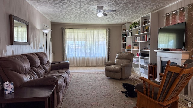 140 W 200 N, Price, UT 84501 - living room featuring ceiling fan, an ornate ceiling, ornamental molding, a fireplace, and wood finished floors