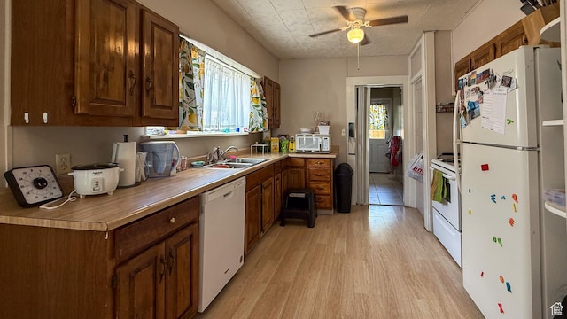 140 W 200 N, Price, UT 84501 - kitchen featuring white appliances, a sink, light wood-style floors, a ceiling fan, and light countertops