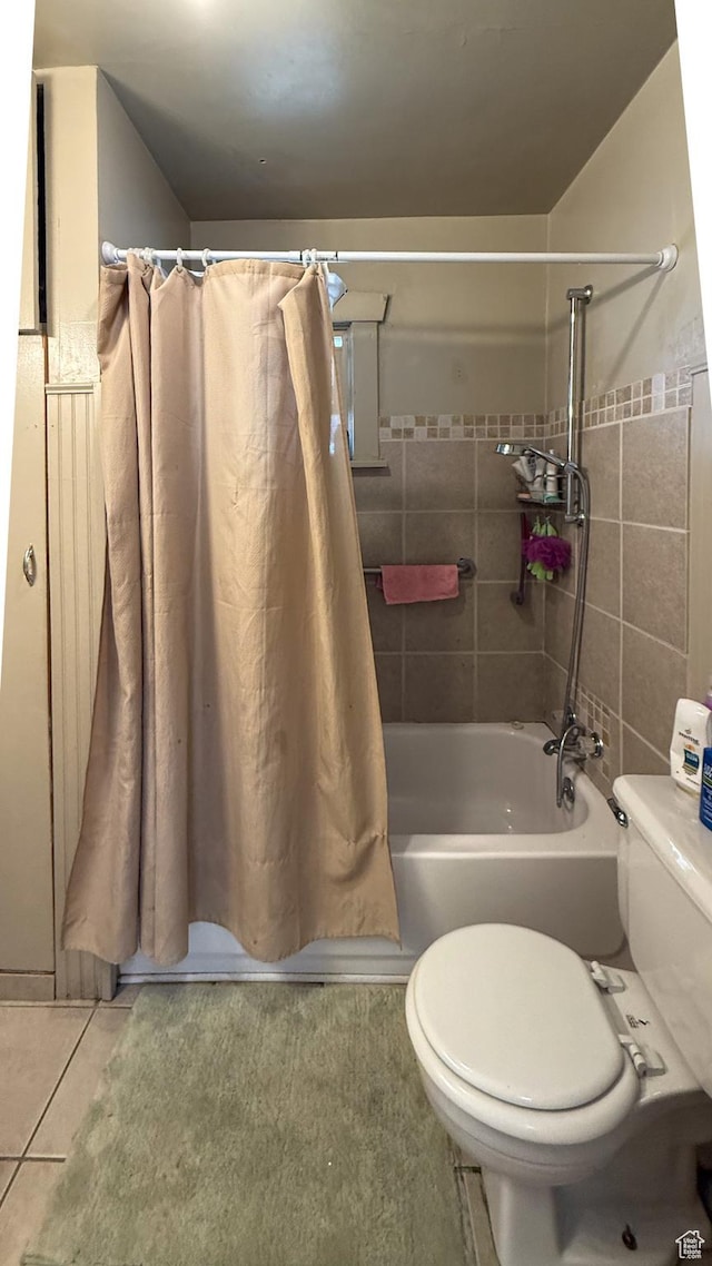 140 W 200 N, Price, UT 84501 - full bathroom featuring toilet, tile patterned flooring, shower / bath combo with shower curtain, and tile walls